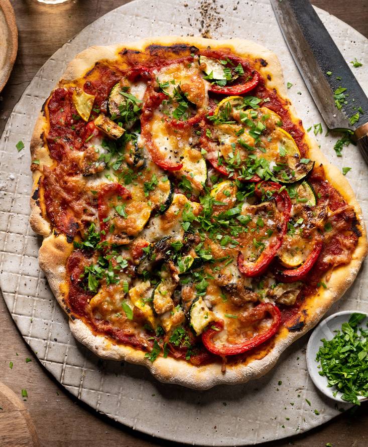 Grilled pizza with tomato sauce and grilled vegetables