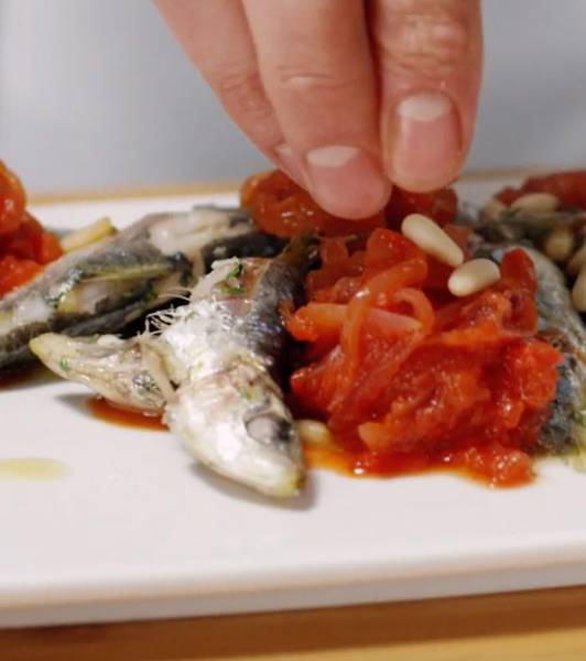 Sardines with onions cooked in tomato reduction sauce