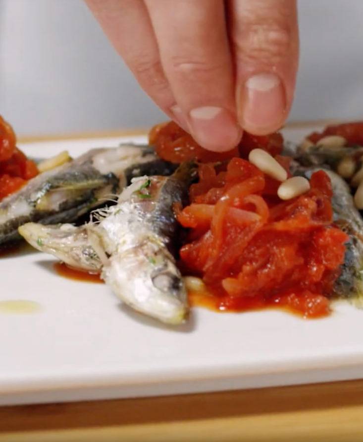 Sardines with onions cooked in tomato reduction sauce